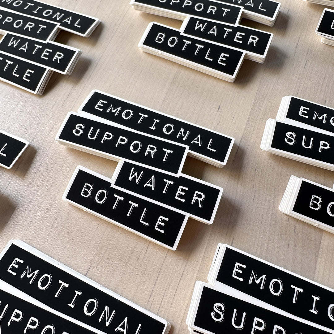 Emotional support water bottle sticker stacked in piles