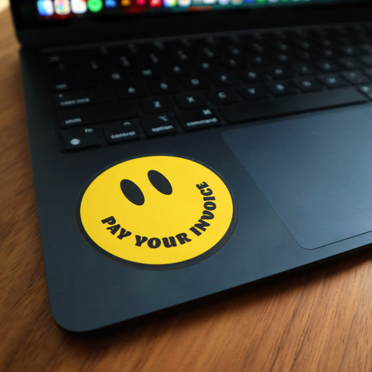 Pay your invoice sticker on a laptop