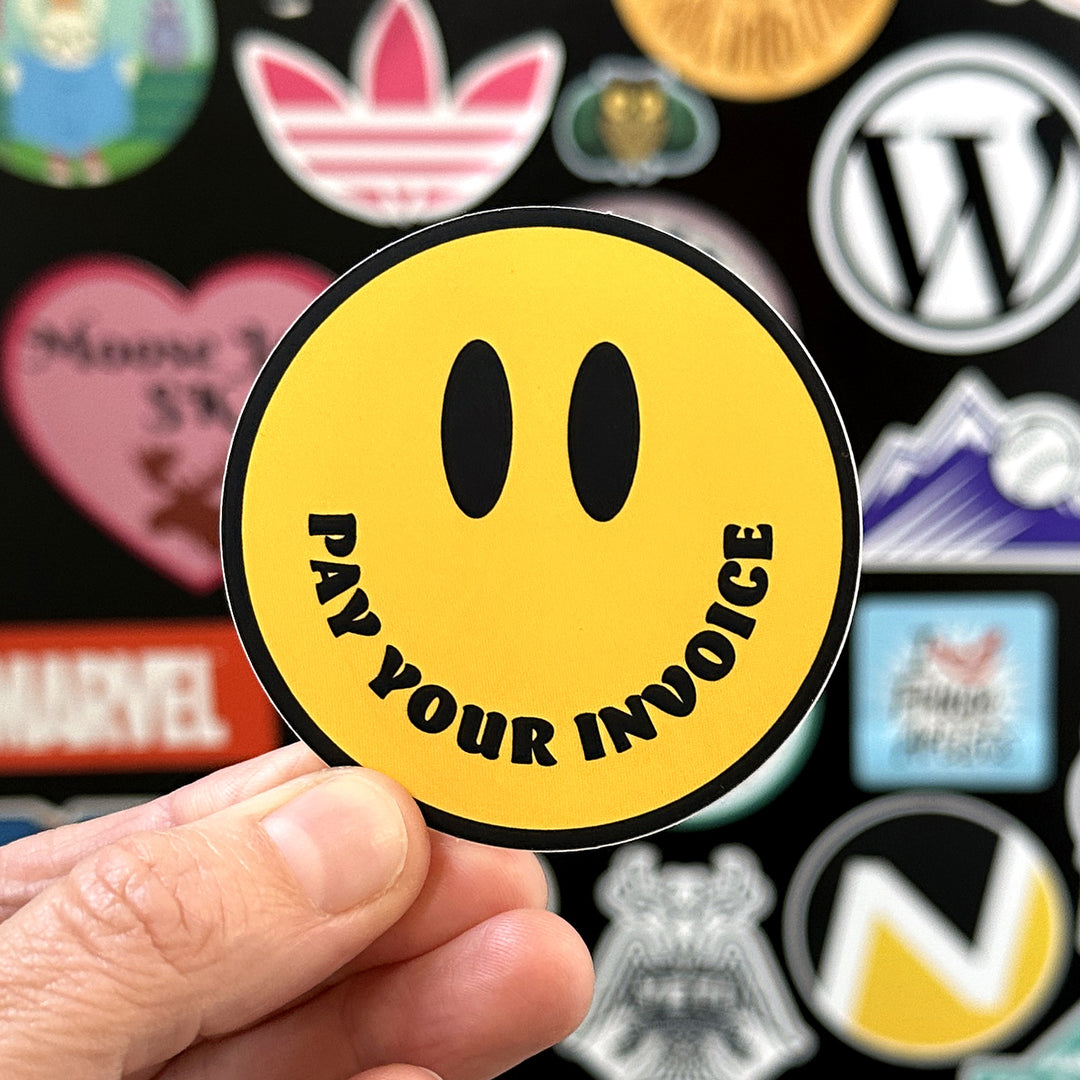 Pay your invoice sticker being held with a sticker door in the background